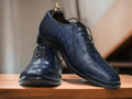 These Blue Alligator Print Leather Oxfords Shoes combine sturdy Italian leather with a classic oxford style for an exquisite look. The alligator print adds a unique style to the classic design, making these shoes the perfect choice for any occasion.