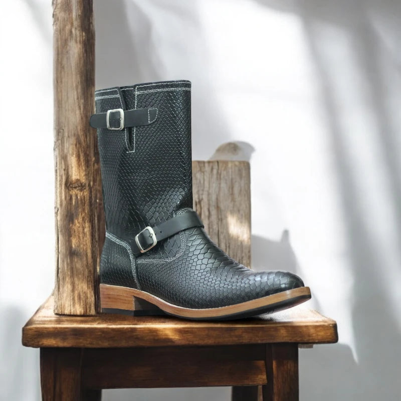 Side profile of black leather engineer boots, showcasing sleek design.