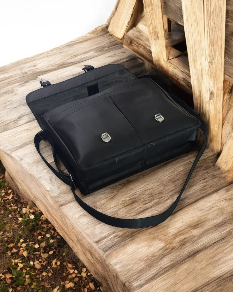 Black leather briefcase with brass hardware and buckle straps