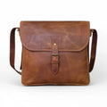 Front view of the leather crossbody bag – Showcasing the stylish saddle brown finish with a secure tick lock closure.
