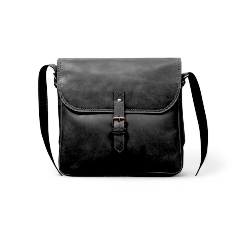 6️⃣ Leather satchel displayed with everyday essentials – Perfectly fits an iPad, phone, wallet, and notebook.
