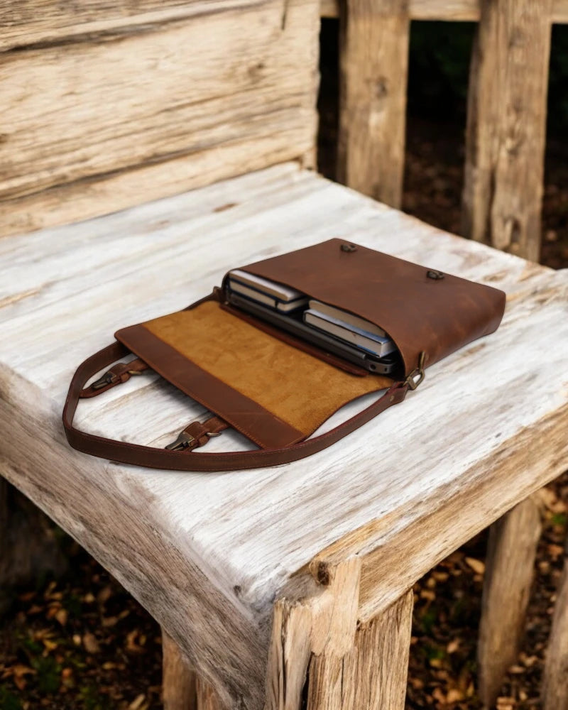 Brown leather crossbody laptop bag with reinforced stitching