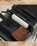 Close-up of high-quality stitching on a black leather messenger bag