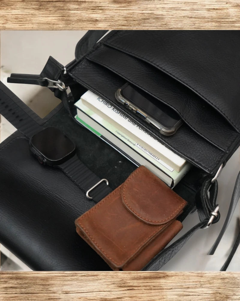 Close-up of high-quality stitching on a black leather messenger bag