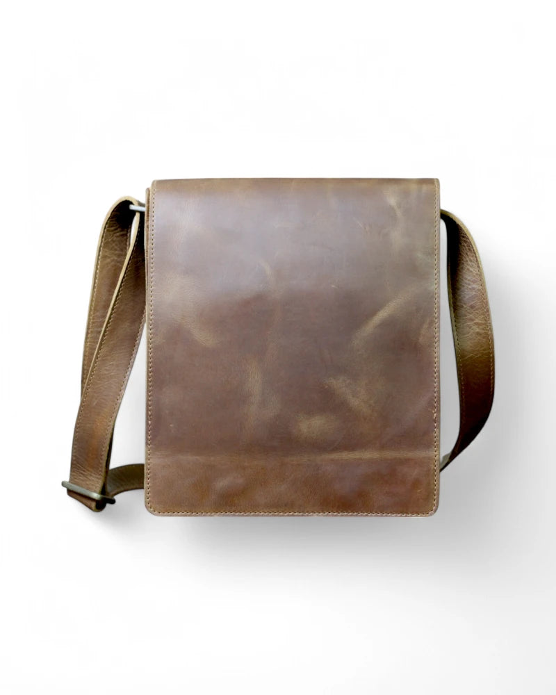 Man wearing a brown leather messenger bag crossbody style