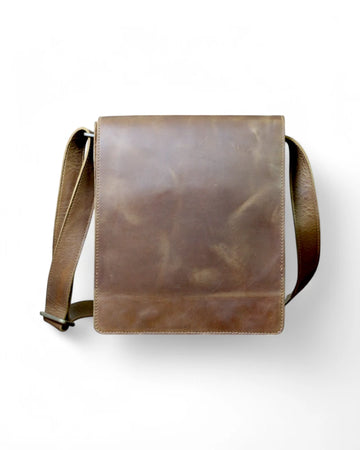 Man wearing a brown leather messenger bag crossbody style