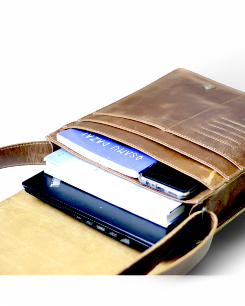 Brown leather messenger bag with magnetic snap closure