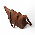 Tip View  on the leather tote, demonstrating the personalization option.

